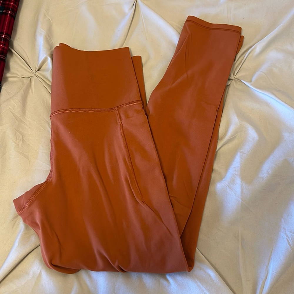 Athleta Salutation Stash Pocket II 7/8 Tight in Burnt Orange